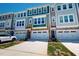 Townhome exterior featuring modern architecture, neutral colors, and attached garages at 2337 Bay Minette Sta # 553, Apex, NC 27502