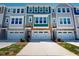 Townhome exterior showcasing modern architecture, stone accents, and attached garages at 2337 Bay Minette Sta # 553, Apex, NC 27502