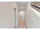 Carpeted hallway with white walls, white doors and trim, and natural light at 2337 Bay Minette Sta # 553, Apex, NC 27502