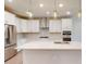 Modern white kitchen with stainless steel appliances and quartz countertops at 2337 Bay Minette Sta # 553, Apex, NC 27502