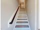 Interior shot of stairs showcasing wood railing, white risers and light gray steps at 2337 Bay Minette Sta # 553, Apex, NC 27502