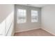 Well-lit bedroom with carpet and two windows at 2370 Bay Minette Sta # 697, Apex, NC 27502