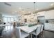 Modern dining area with gray chairs and a long white table, adjacent to the kitchen at 2370 Bay Minette Sta # 697, Apex, NC 27502