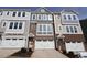 Three-story townhome with brick and siding, two-car garage, and landscaping at 2370 Bay Minette Sta # 697, Apex, NC 27502