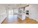 Modern kitchen with white cabinetry, stainless steel appliances, hardwood flooring and spacious island at 2370 Bay Minette Sta # 697, Apex, NC 27502