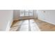 Bright living room features hardwood flooring, recessed lighting, and abundant natural light from large windows at 2370 Bay Minette Sta # 697, Apex, NC 27502