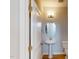 Modern powder room featuring a sleek pedestal sink, oval mirror and updated fixtures and flooring at 2370 Bay Minette Sta # 697, Apex, NC 27502