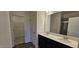 Bright bathroom featuring double vanities, a large mirror, and a walk-in closet at 566 John Stark Dr, Fuquay Varina, NC 27526