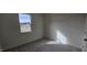 Cozy bedroom with a window offering bright, natural light and neutral carpeting at 566 John Stark Dr, Fuquay Varina, NC 27526