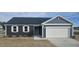 Charming single Gathering home featuring a two car garage, white trim, and dark siding at 566 John Stark Dr, Fuquay Varina, NC 27526