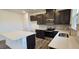 Well-lit kitchen featuring a center island, stainless steel appliances, and stylish gray backsplash at 566 John Stark Dr, Fuquay Varina, NC 27526