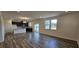 Open concept living room and kitchen featuring hardwood floors and abundant natural light at 566 John Stark Dr, Fuquay Varina, NC 27526