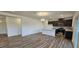 Open concept living room and kitchen featuring hardwood floors, recessed lighting, and natural light at 566 John Stark Dr, Fuquay Varina, NC 27526