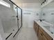 Bright bathroom featuring a walk-in shower with marble tile, and double sink vanity at 57 Bering Cir, Angier, NC 27501