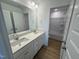 Bright bathroom with double sink vanity, large mirror and walk-in shower at 57 Bering Cir, Angier, NC 27501
