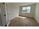 Bright bedroom featuring a large window, wood floor, white trim and neutral wall color at 57 Bering Cir, Angier, NC 27501