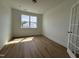 Empty bedroom with wood-look flooring and glass French doors at 57 Bering Cir, Angier, NC 27501