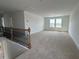 Bright bonus room featuring neutral carpet, white trim and natural light at 57 Bering Cir, Angier, NC 27501