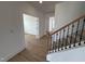 Inviting entryway featuring a staircase and access to a room with glass French doors at 57 Bering Cir, Angier, NC 27501