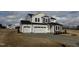 Inviting two-story home featuring a spacious three-car garage and neutral-colored exterior at 57 Bering Cir, Angier, NC 27501
