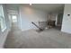 Upstairs hallway featuring neutral carpet, white trim, and natural light from a window at 57 Bering Cir, Angier, NC 27501