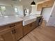 Modern kitchen showcasing a farmhouse sink, white countertop, and wooden cabinets at 57 Bering Cir, Angier, NC 27501