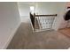 Carpeted staircase featuring stained wood and iron spindles leading to the second floor at 57 Bering Cir, Angier, NC 27501