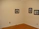 Simple bedroom with warm-toned hardwood floors and neutral walls with artwork at 301 Briarcliff Dr, Dunn, NC 28334