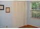 Bright bedroom featuring wood floors, window with blinds, and a large closet with folding doors at 301 Briarcliff Dr, Dunn, NC 28334
