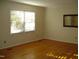 Bedroom featuring hardwood floors, window, and a mirror at 301 Briarcliff Dr, Dunn, NC 28334
