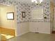 Dining room with floral wallpaper, a window with blinds, and carpet at 301 Briarcliff Dr, Dunn, NC 28334