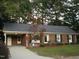Charming one-story brick home with well-manicured lawn and mature trees at 301 Briarcliff Dr, Dunn, NC 28334