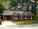 Charming single-story brick home with a well-manicured lawn and mature trees at 301 Briarcliff Dr, Dunn, NC 28334