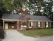 Charming single-story brick home with a well-manicured lawn and mature trees at 301 Briarcliff Dr, Dunn, NC 28334