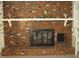 Brick fireplace with hearth and mantle detail at 301 Briarcliff Dr, Dunn, NC 28334