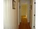 Hallway with light-striped wallpaper and hardwood floors, leading to other rooms at 301 Briarcliff Dr, Dunn, NC 28334