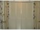 Hallway with bi-fold doors and decorative wallpaper at 301 Briarcliff Dr, Dunn, NC 28334