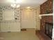 Cozy living room features brick fireplace, and bi-fold closet at 301 Briarcliff Dr, Dunn, NC 28334