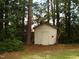 Backyard shed surrounded by lush trees and greenery at 301 Briarcliff Dr, Dunn, NC 28334