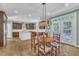 Open kitchen and dining area featuring wood table, dark wood cabinets, and stainless appliances at 5335 Cypress Ln, Raleigh, NC 27609