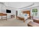 Bright main bedroom features tray ceiling, wooden furniture, and walk in closet at 5335 Cypress Ln, Raleigh, NC 27609