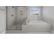 Bathroom features a tiled shower and soaking tub with a window for natural light at 5554 Lake Vista Ct, Rocky Mount, NC 27803