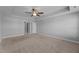 Bedroom with ceiling fan, carpet, neutral paint, and two doors to the hallway and closet at 5554 Lake Vista Ct, Rocky Mount, NC 27803