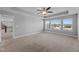 Spacious bedroom shows carpet floors, neutral paint, ceiling fan, and large windows at 5554 Lake Vista Ct, Rocky Mount, NC 27803