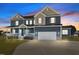 Beautiful two-story home featuring a covered front porch and an attached two-car garage at 5554 Lake Vista Ct, Rocky Mount, NC 27803