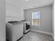 Laundry room showcases a washer and dryer, patterned floor tile, and a window at 5554 Lake Vista Ct, Rocky Mount, NC 27803