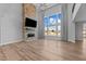 Bright open living room with stone fireplace, wood floors, and a view to the landscaped property at 5554 Lake Vista Ct, Rocky Mount, NC 27803