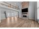 Bright, open living room features a stone fireplace, wood floors, and a view of the second-floor landing at 5554 Lake Vista Ct, Rocky Mount, NC 27803