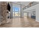 Bright living room featuring hardwood floors, a stone fireplace, and large windows at 5554 Lake Vista Ct, Rocky Mount, NC 27803