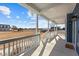 Inviting covered porch with white railings overlooks a spacious yard with beautiful views at 5554 Lake Vista Ct, Rocky Mount, NC 27803